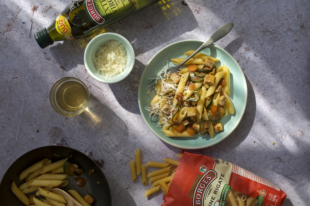 Penne with zucchini served with parmesan cheese and Borges olive oil