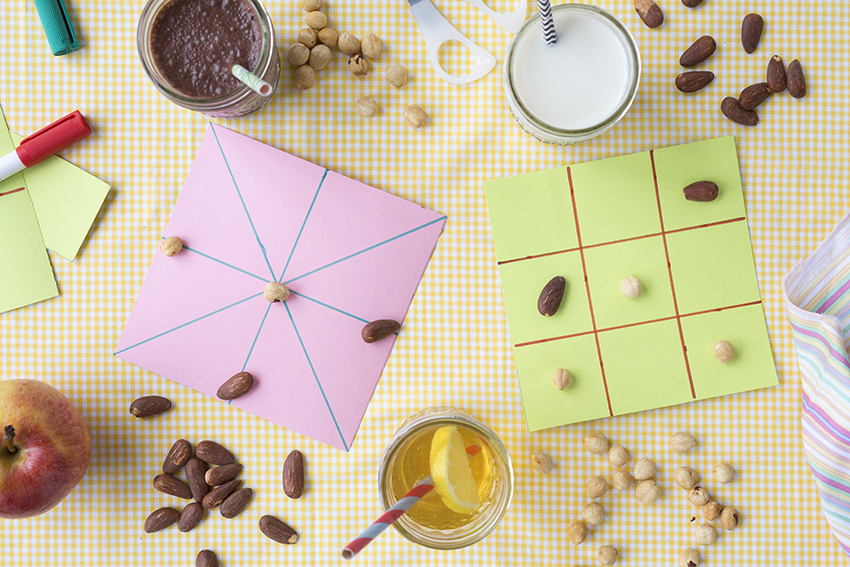 noughts and crosses game and nuts as chips - Healthy games