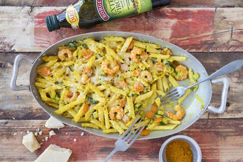 Baked pasta with vegetables and prawns recipe served in an oven tray