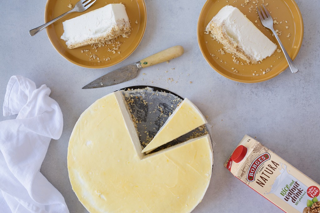 Lemon cheesecake cut and served on a tray with walnut drink