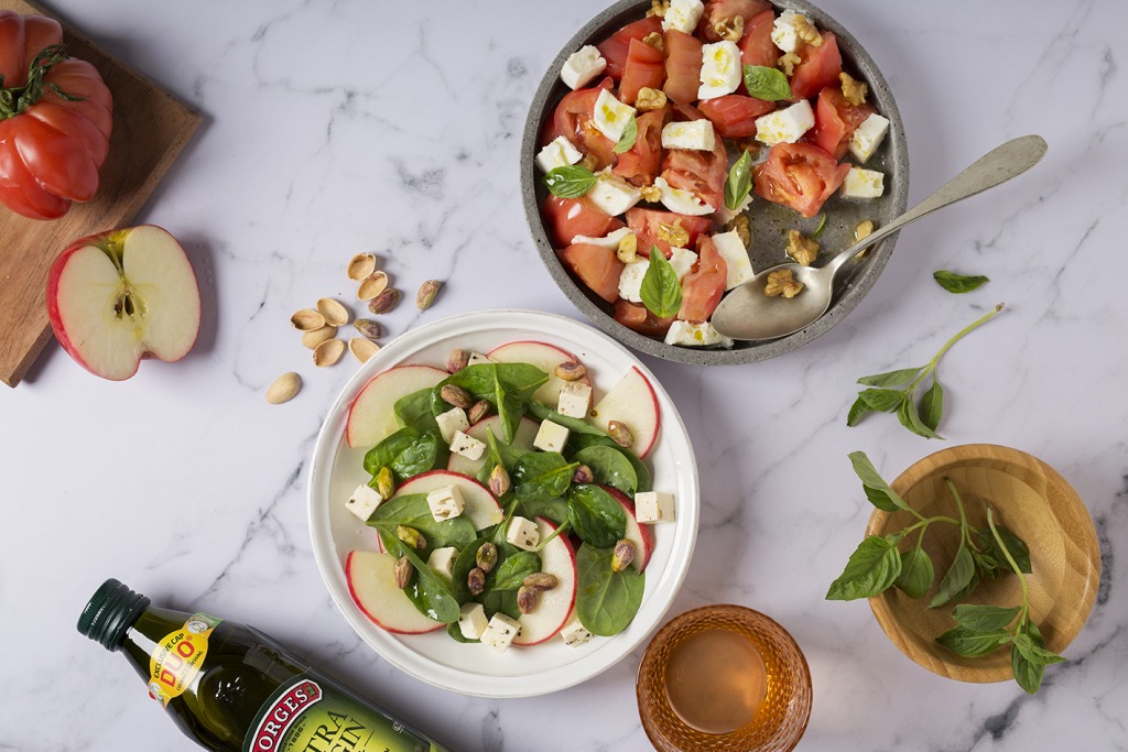 Two salads with nuts and olive oil, two key ingredients for salads