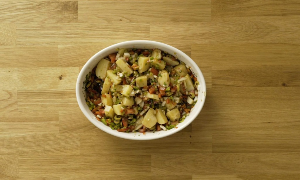 Potato salad recipe served in a white oval platter