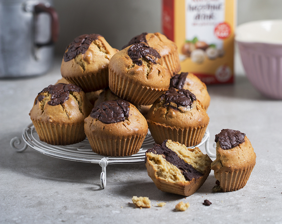 Chocolate pistachio muffins piled on a tray