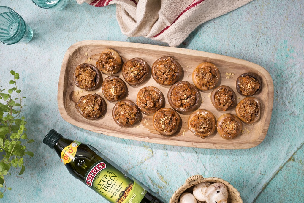 Baked stuffed mushrooms served in a wooden tray