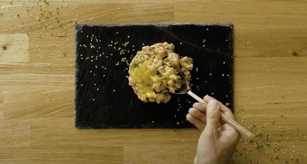 Tartar de salmón servido sobre plato de pizarra