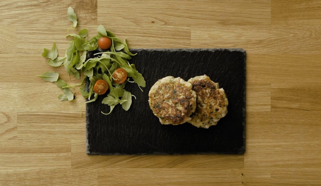 Tuna burgers served on a slate plate with salad