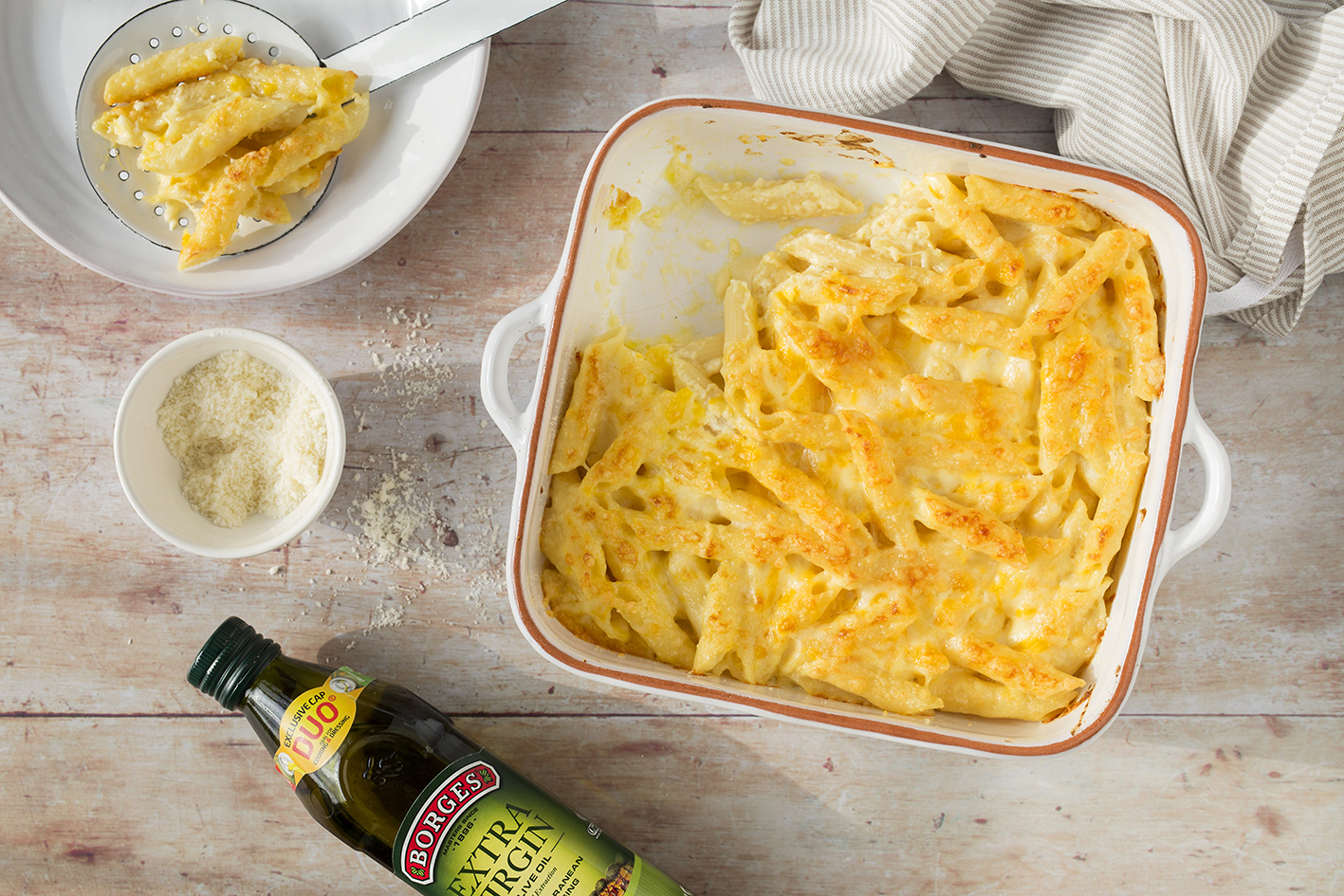 Pasta with cheese au gratin served in an oven white tray